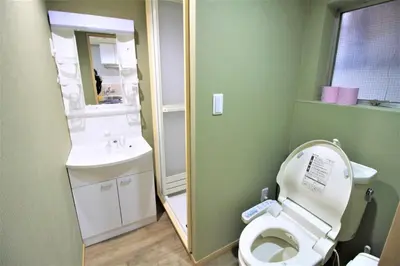 a small bathroom with a toilet and a sink at MW Hotel in Tokyo