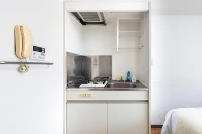 a small kitchen with a sink and a stove at \u30a2\u30b9\u30d4\u30a2502 7-minute walk from Nishi-Sugamo Station 9-minute walk from Sugamo Station 1-minute walk from Koshinzuka WiFi available in Tokyo