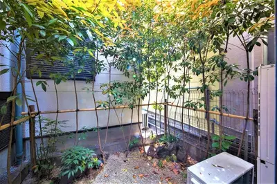 a fence with trees in front of a building at \u304b\u307e\u3082\u30551 in Tokyo