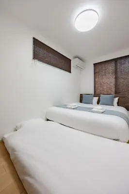 two beds sitting next to each other in a bedroom at First Choice Minami Kamata in Tokyo
