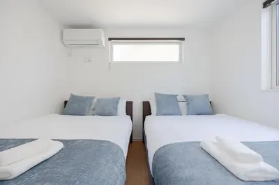 two beds sitting next to each other in a room at First Choice Minami Kamata in Tokyo