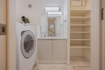 a washing machine in a bathroom with a sink at First Choice Minami Kamata in Tokyo