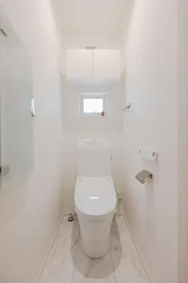 a white toilet in a white bathroom with a window at First Choice Minami Kamata in Tokyo