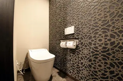 a bathroom with a toilet and a wall at S-rea TOKYO in Tokyo