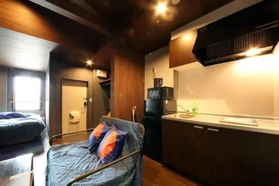 a small kitchen with a couch in a room at S-rea TOKYO in Tokyo