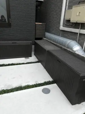 a patio with snow on the ground next to a building at S-rea TOKYO in Tokyo