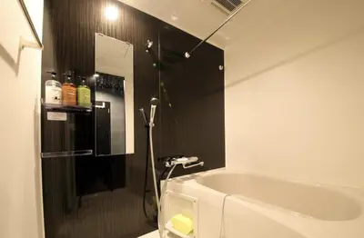 a bathroom with a bath tub and a shower at S-rea TOKYO in Tokyo