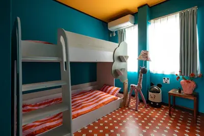 a bedroom with two bunk beds and blue walls at Private house 100sqm with bicycles Disney 30min in Tokyo