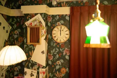a clock and a lamp on a wall with flowers at Private house 100sqm with bicycles Disney 30min in Tokyo