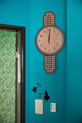 a clock hanging on a blue wall next to a door at Private house 100sqm with bicycles Disney 30min in Tokyo