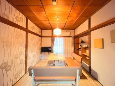 a dining room with a table and a bench at Akabane Nishi kodate AN1 in Wada