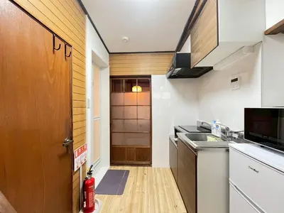 a small kitchen with a sink and a refrigerator at Akabane Nishi kodate AN1 in Wada