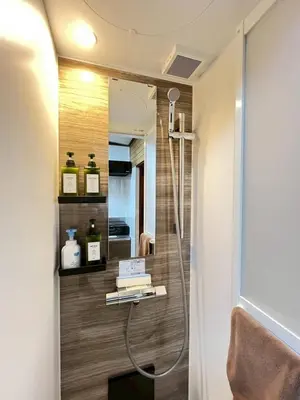 a bathroom with a shower and a mirror at Akabane Nishi kodate AN1 in Wada