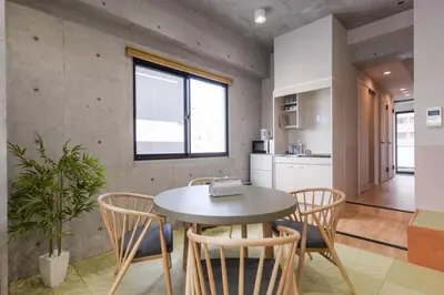 a kitchen and dining room with a table and chairs at \u539f\u7530\u5c4b Hotel 7F in Tokyo