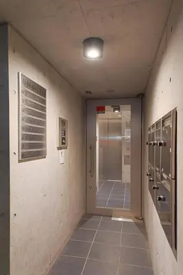 an empty hallway with a door in a building at \u539f\u7530\u5c4b Hotel 7F in Tokyo