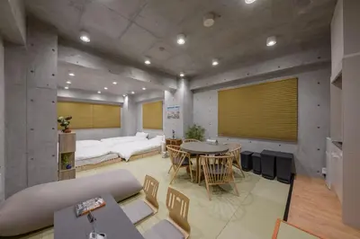 a living room with a couch and a table at \u539f\u7530\u5c4b Hotel 7F in Tokyo