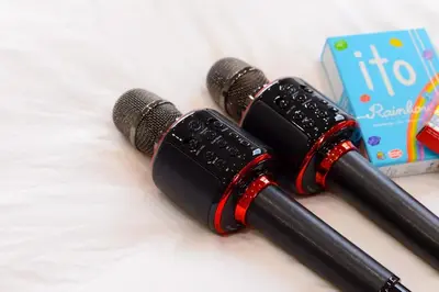 two microphones sitting on a bed next to a box at \u539f\u7530\u5c4b Hotel8F in Tokyo