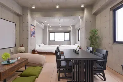 a room with a dining table and a bedroom at \u539f\u7530\u5c4b Hotel8F in Tokyo