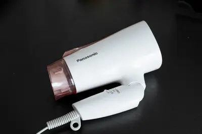 a hair dryer and a brush on a table at Kabukicho Queen Bed Hotel in Tokyo