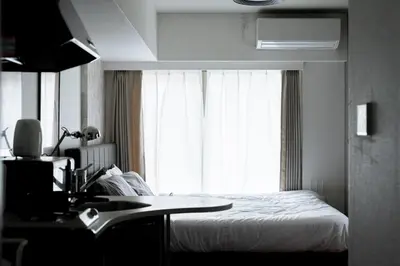 a bedroom with a bed and a sink and a window at Kabukicho Queen Bed Hotel in Tokyo