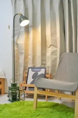 a living room with a chair and a lamp at miraisya shinkoiwa in Tokyo
