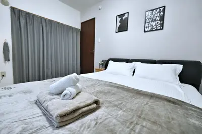 a bedroom with a bed with towels on it at miraisya shinkoiwa in Tokyo