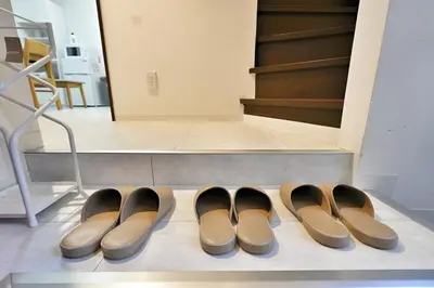 a row of pairs of shoes sitting on a floor at miraisya shinkoiwa in Tokyo