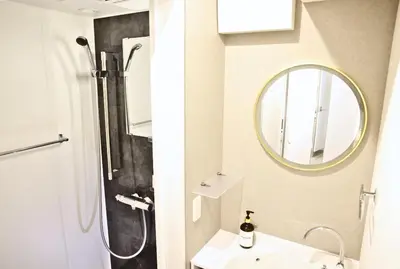 a bathroom with a shower and a sink and a mirror at Miu Hotel Togoshi Ginza - Festival Vibes Every Day with Easy Access to Landmarks, Bullet Train & Airports in Tokyo