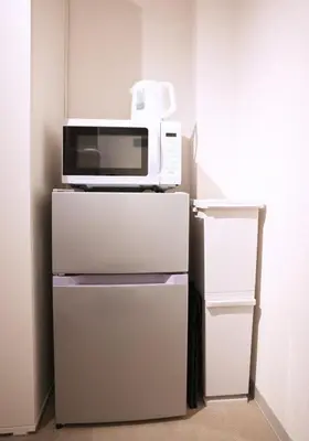 a microwave sitting on top of a refrigerator at Miu Hotel Togoshi Ginza - Festival Vibes Every Day with Easy Access to Landmarks, Bullet Train & Airports in Tokyo