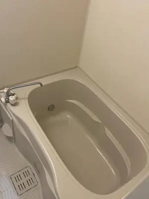 a white bath tub sitting in a bathroom at Central Tokyo,Skytree 2min by train,Akihabara 6min,Asakusa 10min,Shinjuku 22min direct access for each in Tokyo