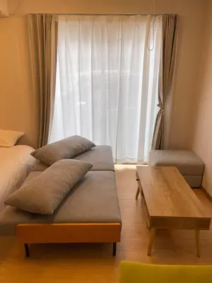 a room with two beds and a table and a window at Central Tokyo,Skytree 2min by train,Akihabara 6min,Asakusa 10min,Shinjuku 22min direct access for each in Tokyo
