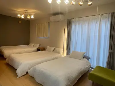 a hotel room with two beds and a window at Central Tokyo,Skytree 2min by train,Akihabara 6min,Asakusa 10min,Shinjuku 22min direct access for each in Tokyo