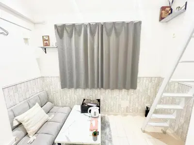 a living room with a couch and a window at Green house Japan in Tokyo
