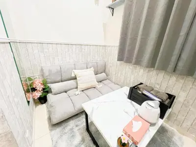 a living room with a couch and a table at Green house Japan in Tokyo