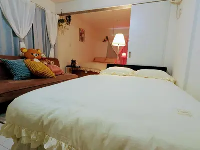 a bedroom with a teddy bear sitting on a bed at The Tokyo Okubo Shinjuku Homestay in Tokyo