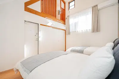 a bedroom with a white bed and a window at Kei House Shin-Okubo in Tokyo