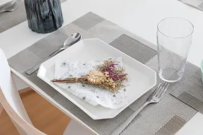 a white plate with flowers on it on a table at DREAM STAY Urayasu in Tokyo