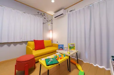 a living room with a yellow couch and a table at DREAM STAY Urayasu in Tokyo