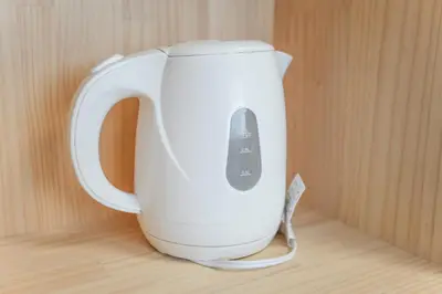 a white electric kettle with a remote control in it at Asakusa 5 Chome One Bedroom KazeNoItsu 101 in Tokyo