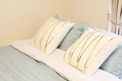 two pillows sitting on top of a bed at \u30d5\u30e9\u30c3\u30c8\u5409\u6751 202 in Tokyo