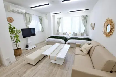 a white living room with two beds and a couch at Oliver 501 in Tokyo