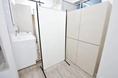 a bathroom with white cabinets and a sink at Oliver 501 in Tokyo