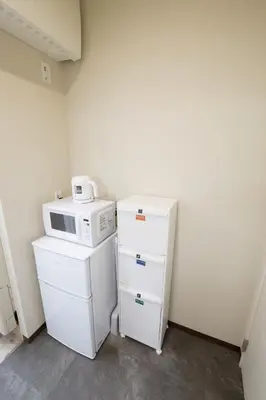 a kitchen with a microwave on top of a refrigerator at Oliver 501 in Tokyo