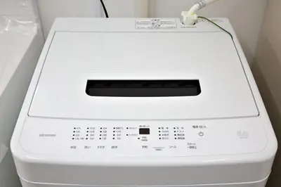 a white washing machine sitting in a room at Oliver 502 in Tokyo