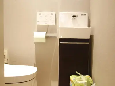 a small bathroom with a sink and a toilet at Ermitage \u6e0b\u8c37\u672c\u753a \u6238\u5efa in Tokyo