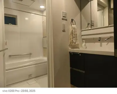 a bathroom with a shower and a toilet and a sink at Ermitage \u6e0b\u8c37\u672c\u753a \u6238\u5efa in Tokyo