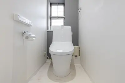a white toilet in a bathroom with a window at Shibuyahonmachi 1F in Tokyo