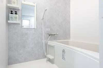 a bathroom with a shower and a tub and a sink at Shibuyahonmachi 1F in Tokyo