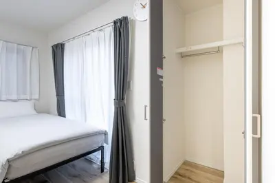 a bedroom with a bed and a window at Shibuyahonmachi 1F in Tokyo