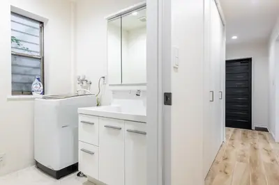 a white bathroom with a sink and a mirror at Shibuyahonmachi 1F in Tokyo